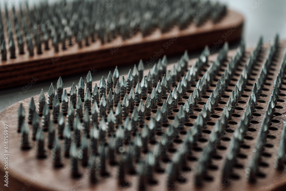 A wooden sadhu board with sharp nails for sadhu practice. Alternative medicine. Macro. Closeup A wooden sadhu board with sharp nails for sadhu practice. Alternative medicine. Macro. Closeup