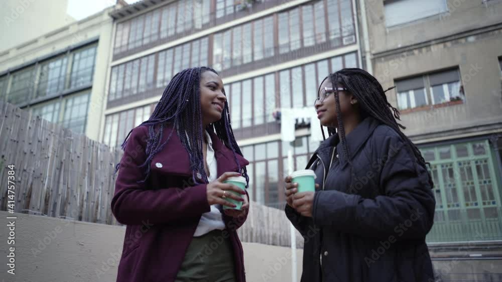 Two businesswomen have coffee after work and talk about new projects during a break in their office. Two businesswomen have coffee after work and talk about new projects during a break in their office.