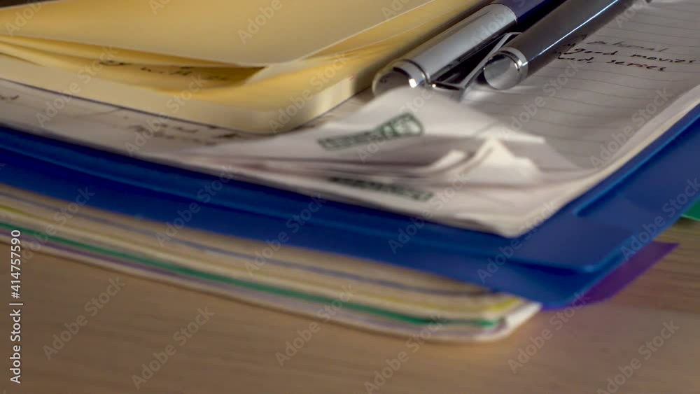 Notebooks arranged in stack on a desk Notebooks arranged in stack on a desk