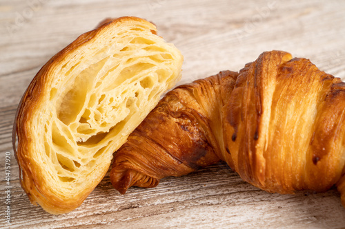 Fresh baked croissants. Freshly baked croissants on wooden table. Close up