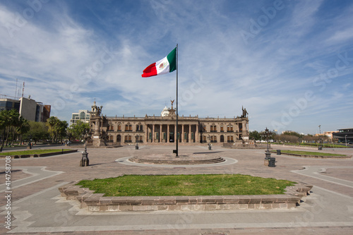 Flag of Mexico with national palace of the Macroplaza of Monterrey
