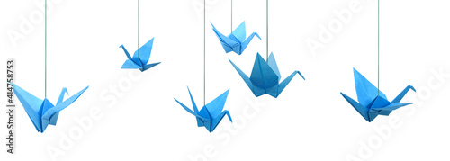 Blue origami paper birds haning isolated white photo