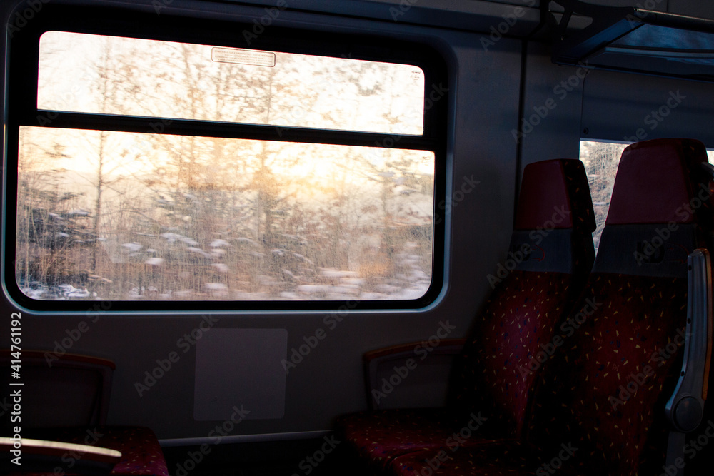 view from the inside of the train to the winter forest and dawn view from the inside of the train to the winter forest and dawn
