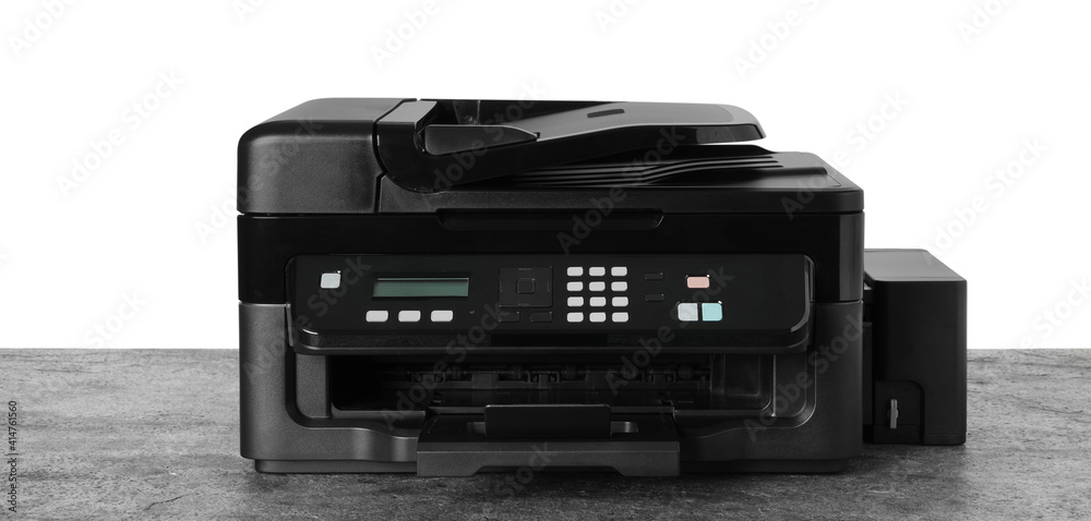New modern multifunction printer on grey table New modern multifunction printer on grey table