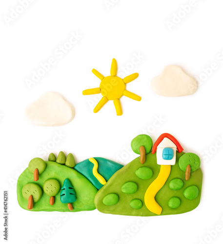 plasticine landscape, meadows, trees, house sun clouds on a white background photo