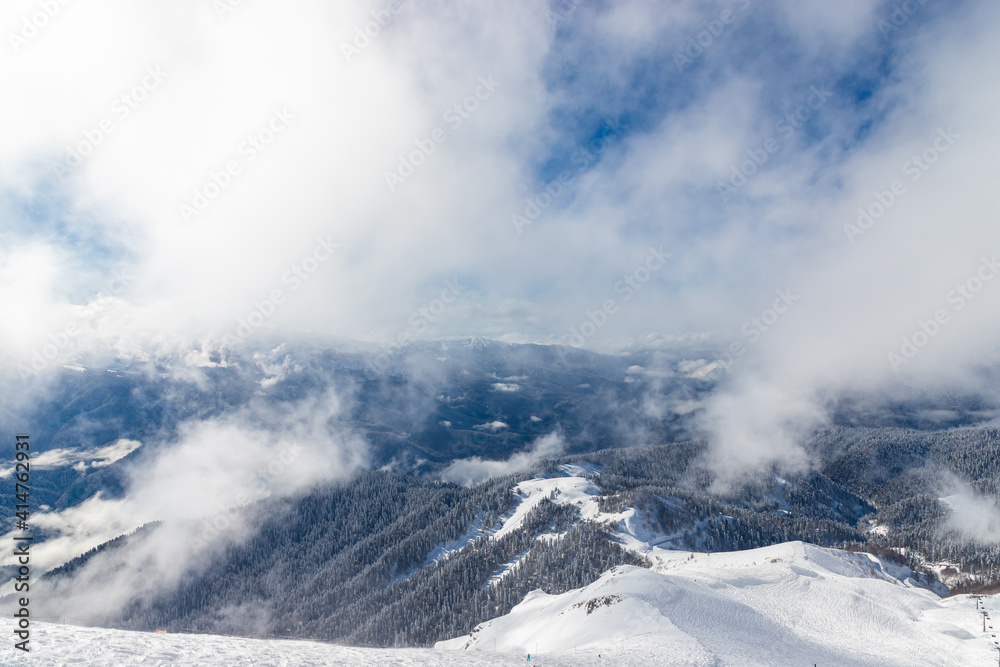 Beautiful snow landscape of snowy trees and ski slope of Roza Khutor ski resort. South part of mountains with sunny weather. Sochi, Russia. Beautiful snow landscape of snowy trees and ski slope of Roza Khutor ski resort. South part of mountains with sunny weather. Sochi, Russia.