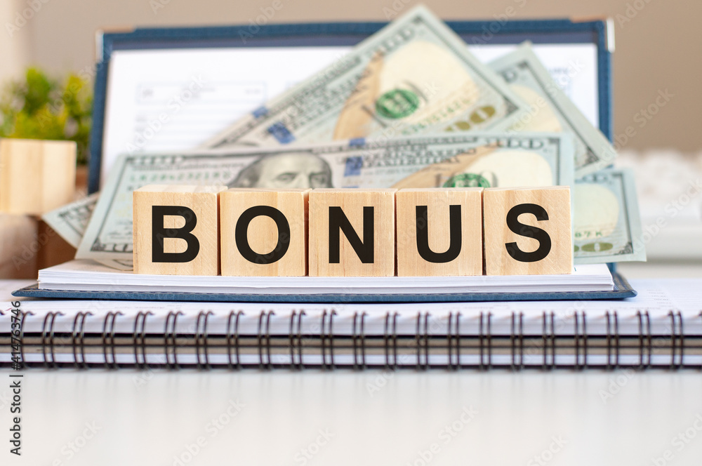 Wooden blocks with the word Bonus. Capital gains. Market trading and pricing. Wooden blocks with the word Bonus. Capital gains. Market trading and pricing.