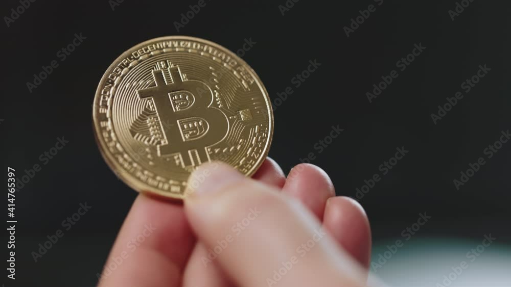 Close up of male hand holding glowing bitcoin sign. Financial growth and virtual money. Successful investments. Trading and economy concept. Close up of male hand holding glowing bitcoin sign. Financial growth and virtual money. Successful investments. Trading and economy concept.
