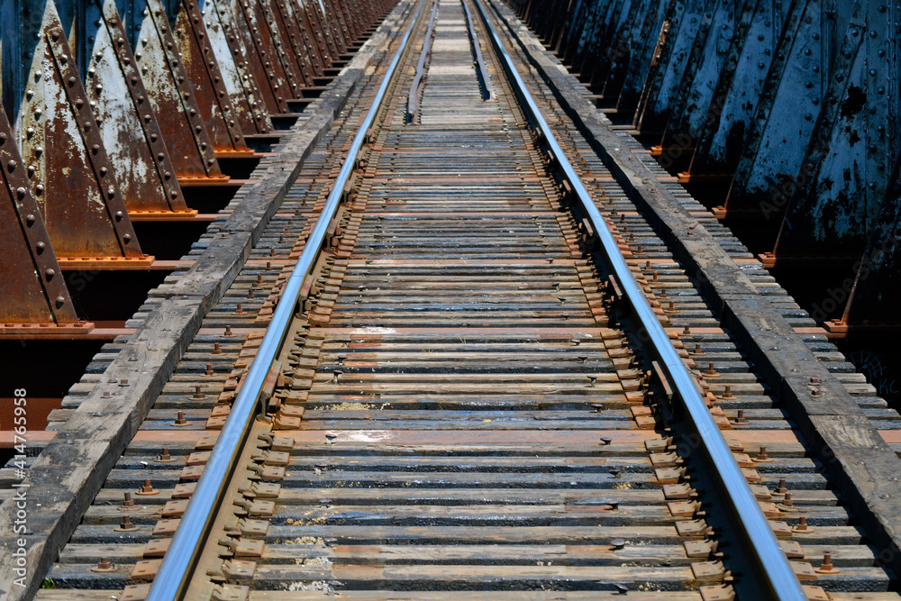 Aged wooden railroad tracks on an old iron railroad bridge Aged wooden railroad tracks on an old iron railroad bridge