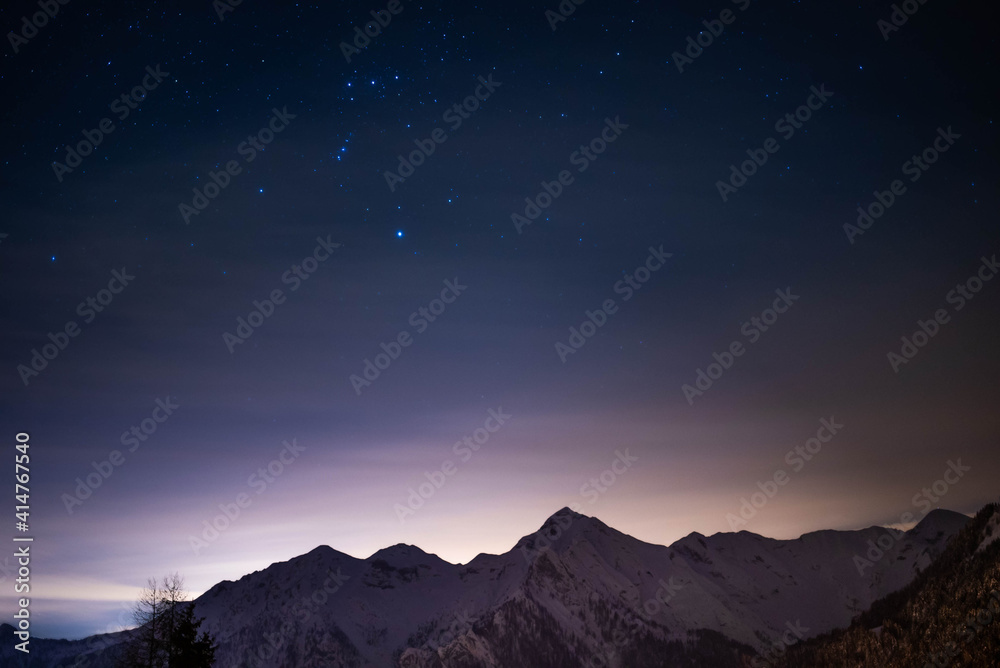 winter night in the alps with snow and stars