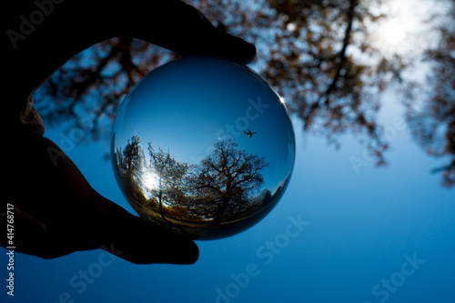 Fototapeta Naklejka Na Ścianę i Meble -  Aeroplane inside a crystal ball with blue sky.