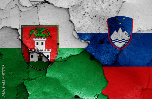 Fotografie flags of Ljubljana and Slovenia painted on cracked wall