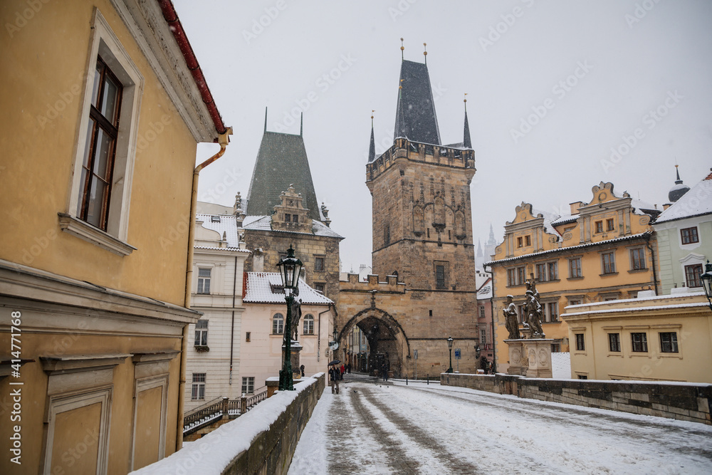 Charles Bridge landmark looking towards Lesser Town with bridge tower, Baroque Church of Saint Nicholas and Prague Castle in background, snow in winter day, Prague, Czech Republic, Charles Bridge landmark looking towards Lesser Town with bridge tower, Baroque Church of Saint Nicholas and Prague Castle in background, snow in winter day, Prague, Czech Republic,