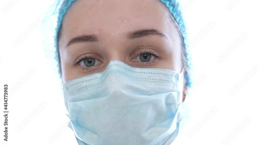 Female doctor during a coronavirus pandemic covid-19 takes off glasses and a protective mask. Close portrait of a tired doctor Female doctor during a coronavirus pandemic covid-19 takes off glasses and a protective mask. Close portrait of a tired doctor
