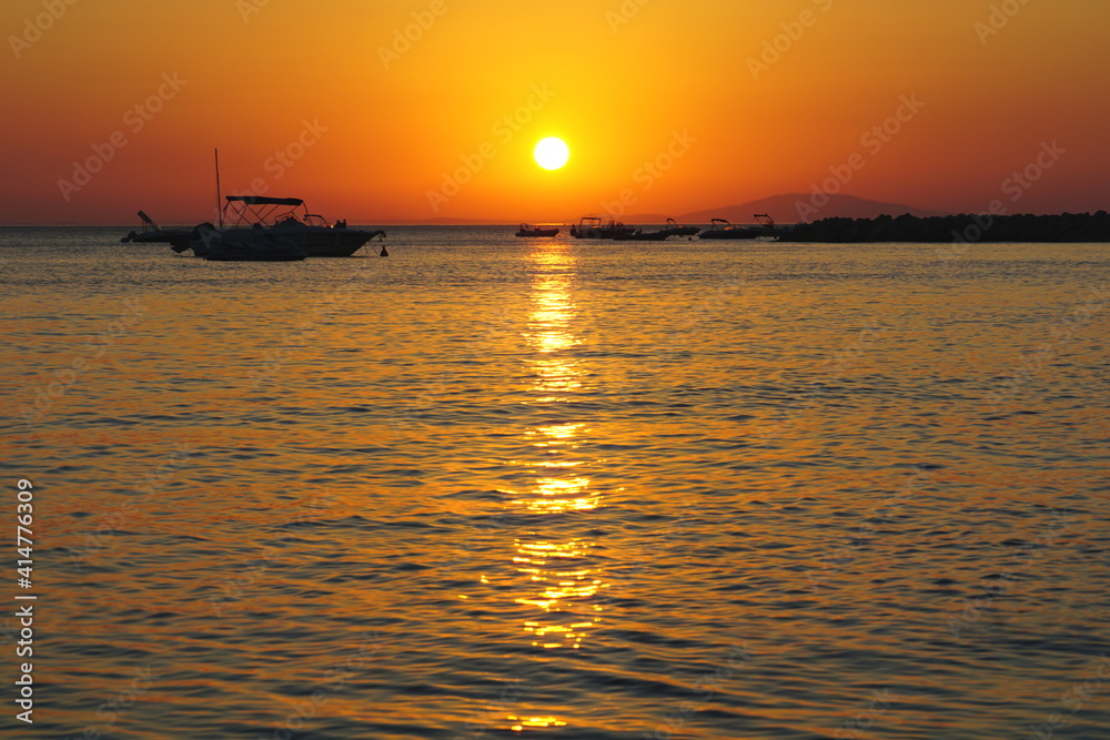 Shiny sun ball above sea horizon in beautiful summer evening