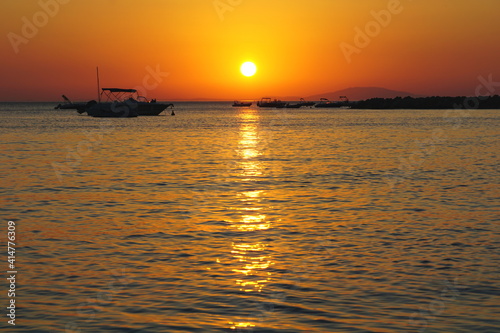 Shiny sun ball above sea horizon in beautiful summer evening