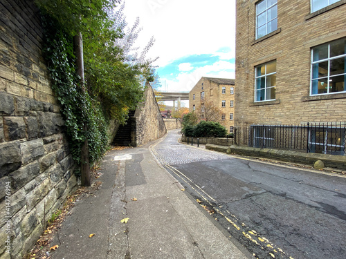 View along, Old Lane, with stone steps, walls, and Victorian buildings in, Halifax, Yorkshire, UK