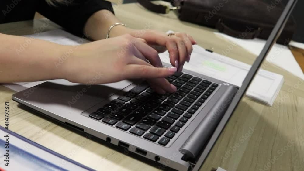 Female hands with pink nails of business woman typing very fast on laptop notebook keyboard sit at home office desk working online with pc software apps technology concept, close up dutch angle view Female hands with pink nails of business woman typing very fast on laptop notebook keyboard sit at home office desk working online with pc software apps technology concept, close up dutch angle view