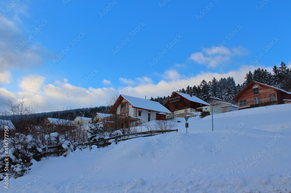 Chalet in winter on the mountain with blue sky 
