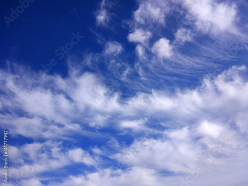 bright blue sky with cirrus white clouds