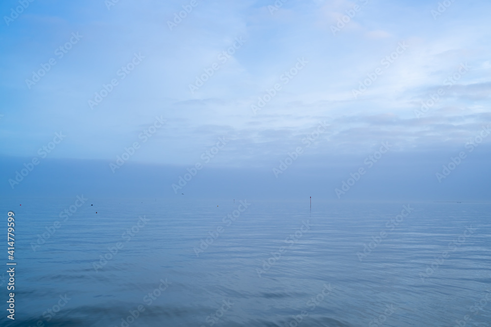 Cloudy blue minimalist seascape. Deserted space with horizon line. 