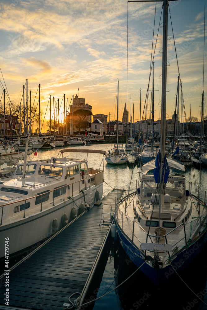 Colorful sailboats at sunset in the old harbor of La Rochelle France 