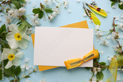 greeting card mockup made of spring flowers, gift box, envelope and white blank for text 