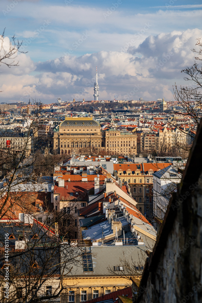 Panorama aerial view of Old town cityscape from Petrin Hill, building of national theater, red roofs and Zizkov television tower in background, sunny day, Prague, Czech Republic