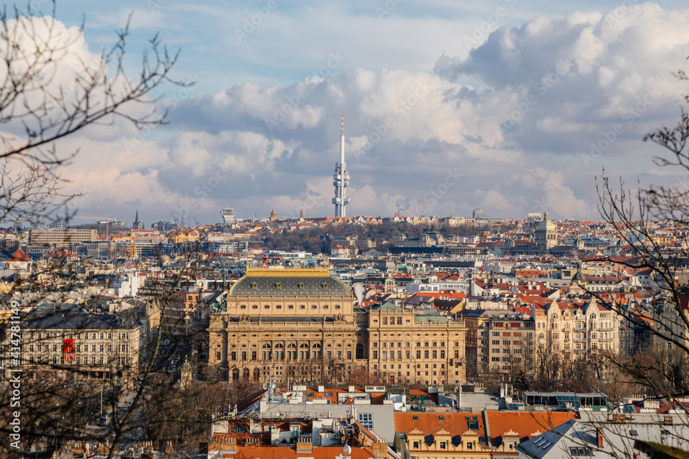 Panorama aerial view of Old town cityscape from Petrin Hill, building of national theater, red roofs and Zizkov television tower in background, sunny day, Prague, Czech Republic