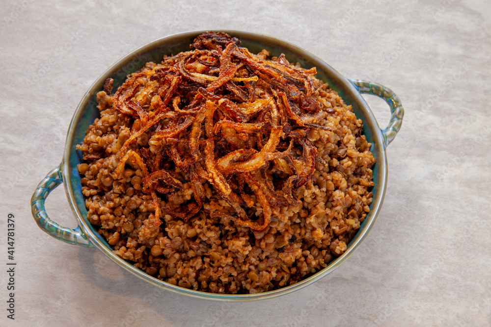 Lentil and bulgur pilaf with fried onion on the top. Palestinian cuisine. Lentil and bulgur pilaf with fried onion on the top. Palestinian cuisine.