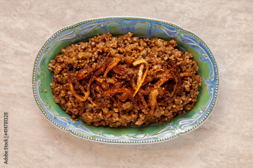 Lentil and bulgur pilaf with fried onion on the top. Palestinian cuisine. photo