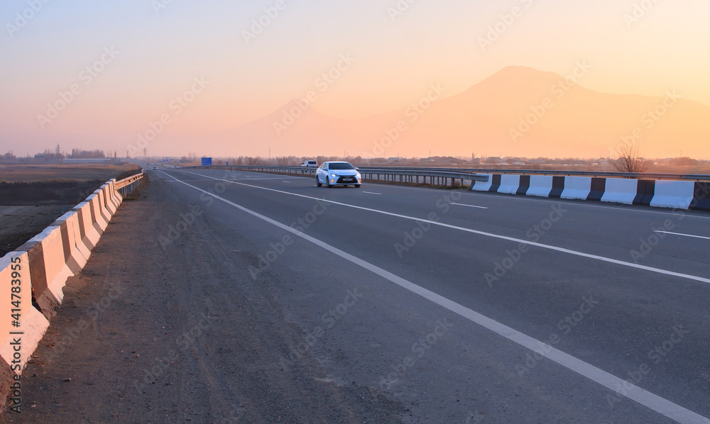 car in asphalt road in Ararat background