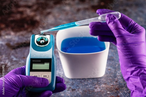 Digital Refractometer. A refractometer is a laboratory or field device for the measurement of an index of refraction photo