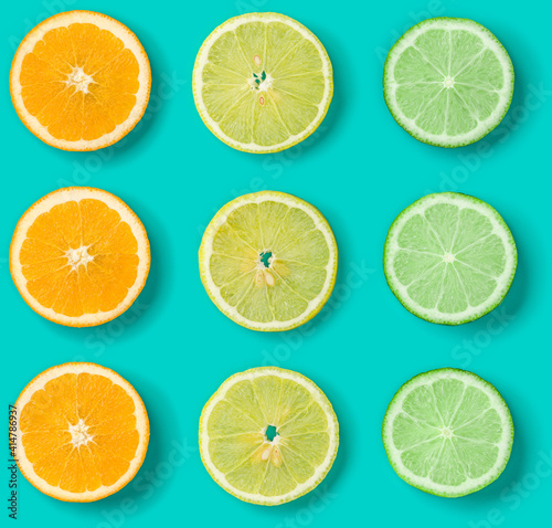 Citrus Fruit pattern on blue background. Orange, Lime, Lemon slices background. Flat lay, top view. . Pop art design, creative summer concept.