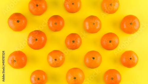 Fruit pattern of mandarin isolated on yellow background. Tangerine. Flat lay  top view.