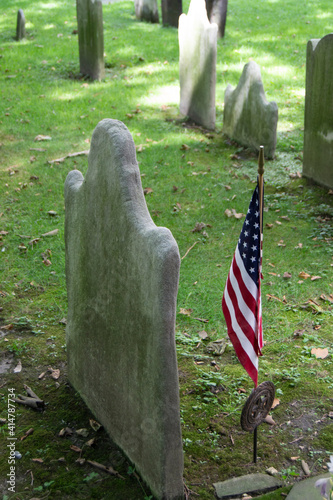 
Headstone in cemetery with American flag