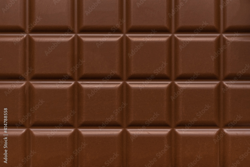 Milk chocolate bar close up. Chocolate texture. Milk chocolate bar close up. Chocolate texture.