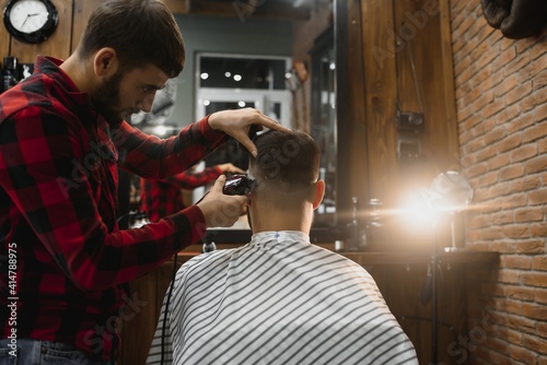 Serious Young Bearded Man Getting Haircut By Barber. Barbershop Theme