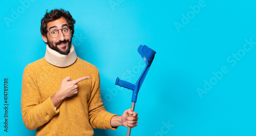 young crazy bearded man who is suffering pain. accident concept photo