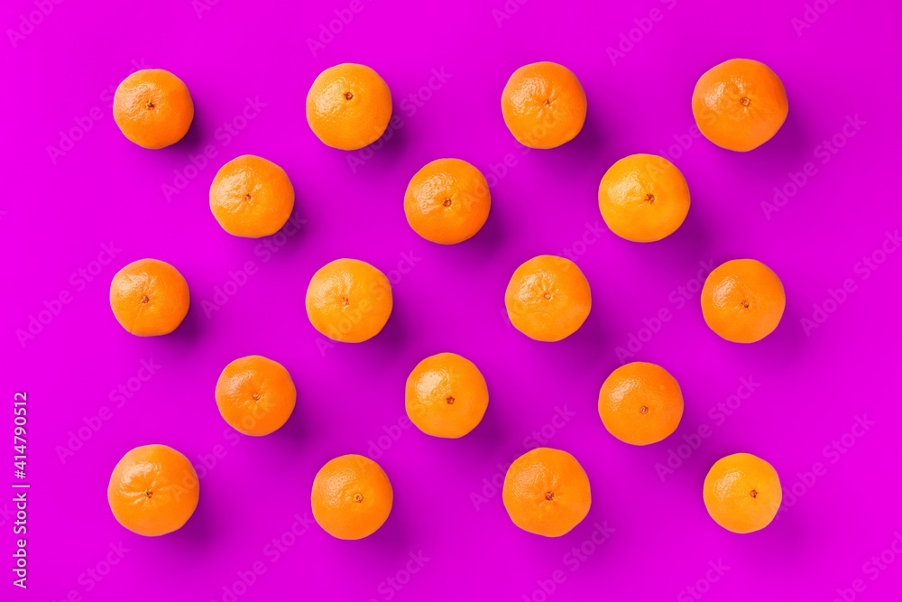 Fruit pattern of fresh orange tangerine or mandarin on lilac background. Flat lay, top view. Pop art design, creative summer concept. Citrus in minimal style. Fruit pattern of fresh orange tangerine or mandarin on lilac background. Flat lay, top view. Pop art design, creative summer concept. Citrus in minimal style.