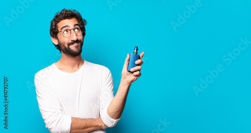 young bearded man smoking with a vaper