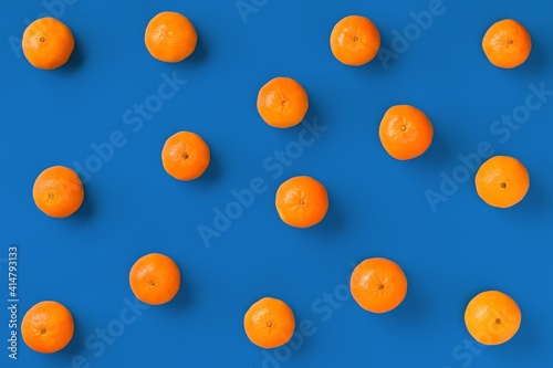 Fruit pattern of fresh orange tangerine or mandarin on blue background. Flat lay  top view. Pop art design  creative summer concept. Citrus in minimal style.
