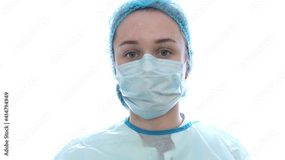Female doctor during a coronavirus pandemic covid-19 takes off glasses and a protective mask. Close portrait of a tired doctor Female doctor during a coronavirus pandemic covid-19 takes off glasses and a protective mask. Close portrait of a tired doctor