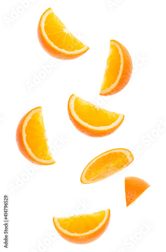 falling fresh orange fruit slices isolated on white background closeup. Flying food concept. Top view. Flat lay. Orange slice in air, without shadow.