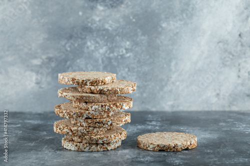 Stack of delicious crispbread on marble background