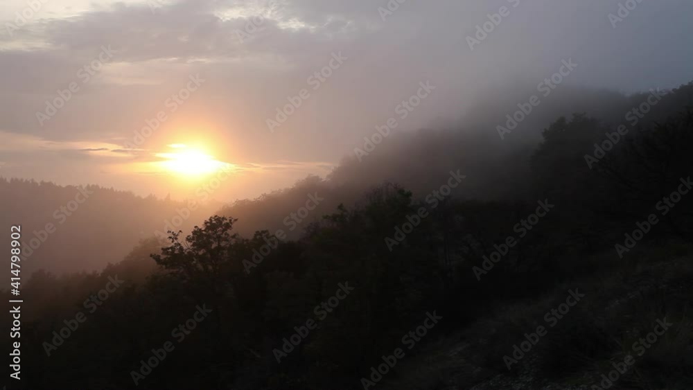 Sunset behind a foggy hill Sunset behind a foggy hill