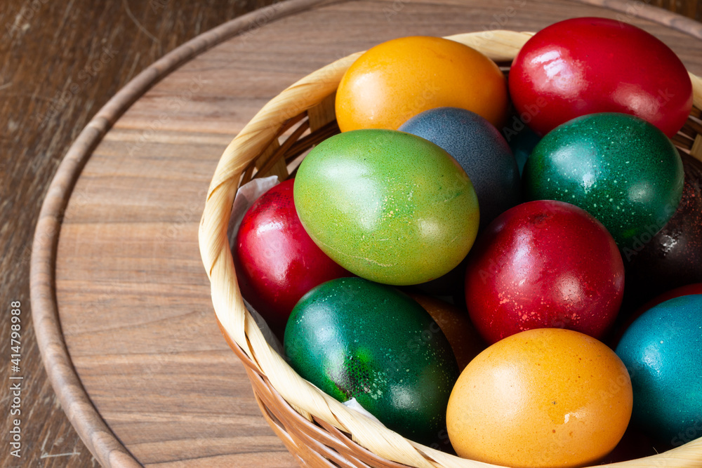 Easter eggs and Easter bun with flowers - wood background Easter eggs and Easter bun with flowers - wood background