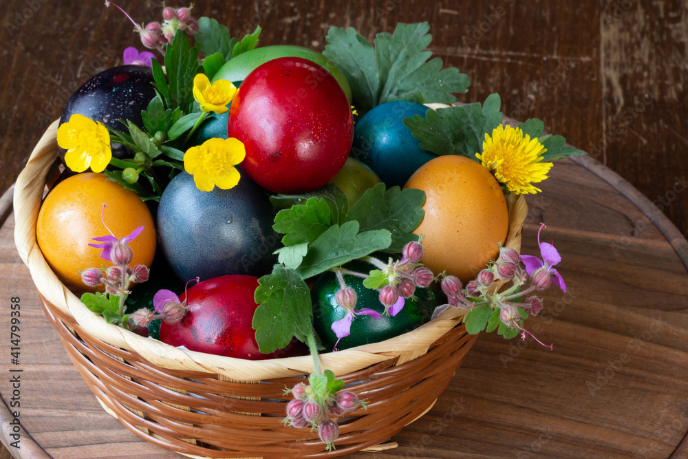 Easter eggs and Easter bun with flowers - wood background