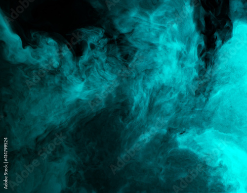 Abstract background of chaotically mixing clouds of turquoise smoke on a background of darkness