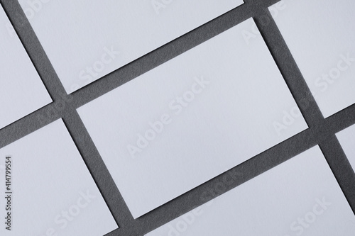 On a grey background white and clean paper, symmetrical sheets, space for text